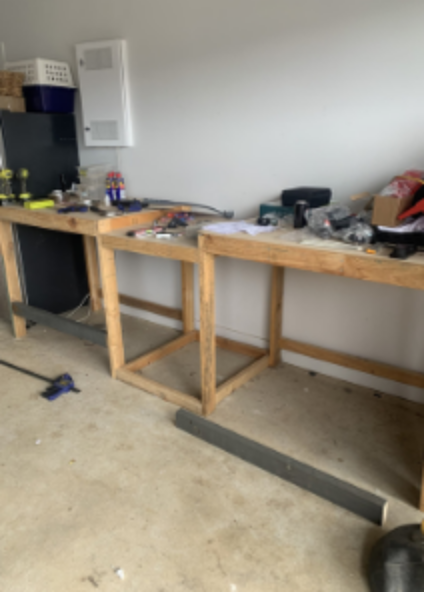 Before: a near-empty, cluttered garage workbench against a bare wall.